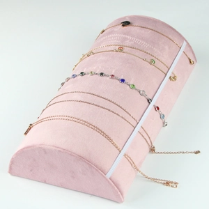 Detail view of pink velvet jewelry display stand for necklaces and bracelets