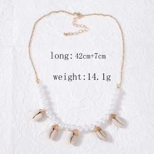 Detailed view of gold shell and pearl necklace with 42cm length and 14.1g weight info