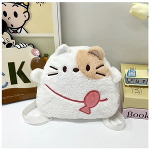 Detail view of white plush cat backpack with fish accessory and soft fluffy texture