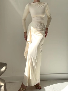 Detail shot of elegant cream bodycon dress featuring artistic side waist draping and pleats