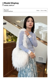 Faux fur white shoulder bag with long plush texture worn by a model in a modern setting