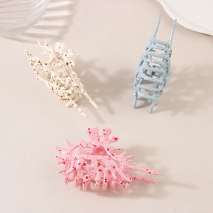 Three conch shell hair claws in beige, blue, and pink patterns for elegant styling