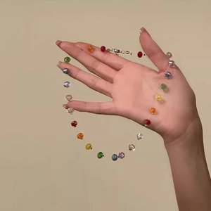 Detailed macro view of colorful faceted rainbow beads necklace with metal clasp and chain