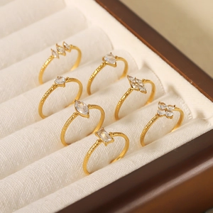 Macro view of gold-plated stainless steel rings with zircon stones in a jewelry box