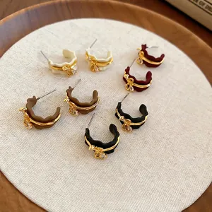 Elegant 18k gold plated wave-shaped C-hoop earrings with rhinestone bow in four colors