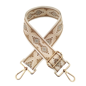 Detail of bohemian geometric jacquard bag strap with light gold metal swivel hooks