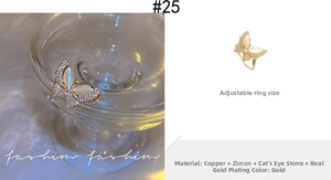 Detail showing gold butterfly ring with opal and zircon, adjustable copper base design