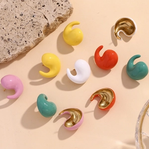 Macro detail of comma-shaped stud earrings in candy colors with 18K gold-plated finish