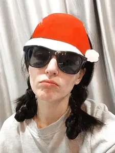 Close-up of black frame party sunglasses worn by a person for Christmas celebrations