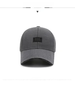 Close-up of dark grey baseball cap with textured fabric and rectangular patch detail