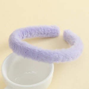 Detail of light purple plush headband with soft faux rabbit fur texture on white ceramic cup