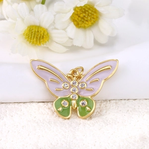 Macro shot of gold-plated butterfly pendant with pink enamel and sparkling rhinestones