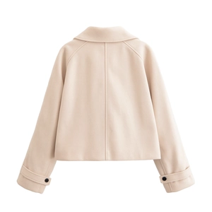 Detail view of the back seams and adjustable buttoned cuffs on the beige wool jacket