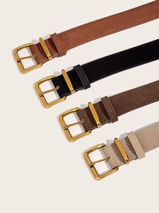 Detail of vintage suede waist belts in caramel and black with gold pin buckles
