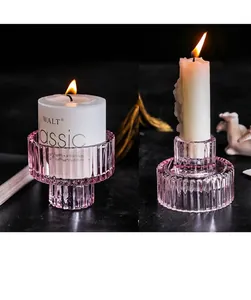 Detail of pink ribbed glass candle holder with dual-use design for various candle types
