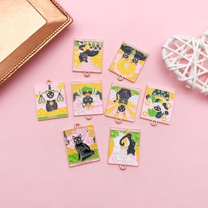 Detailed macro view of eight black cat tarot enamel pendants with gold alloy edges