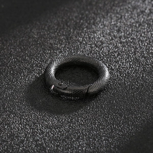 Close-up of matte black stainless steel round spring clasp with snake skin texture