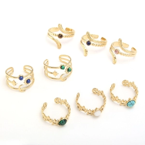 Detailed grid of adjustable gold rings with diverse natural stones and celestial motifs