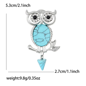 Retro silver owl brooch with turquoise stone and hanging pyramid pendant on white background