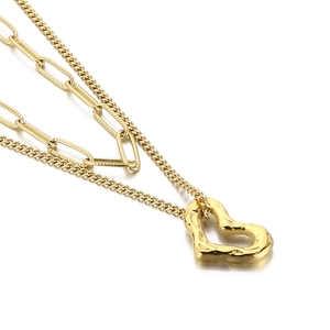 Golden layered paperclip necklace with a textured irregular heart-shaped pendant