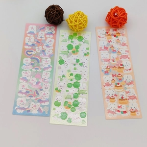 Detailed view of colorful cartoon bear stickers with decorative woven balls on white background