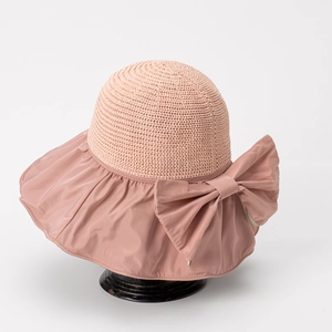Detail of dusty pink sun hat featuring woven top, satin brim and elegant side bow