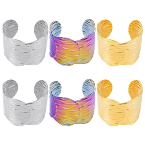 Macro detail of wave textured titanium steel open bracelets in silver gold and rainbow finish