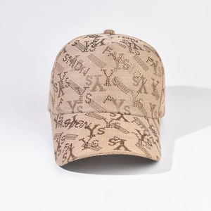 Macro detail of beige baseball cap featuring YS rhinestone embroidery and woven texture