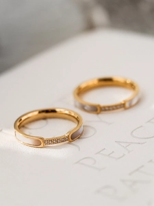 Macro shot of 18K gold plated ring featuring white shell inlay and zircon accents