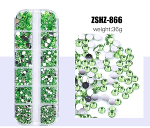 Macro shot of green resin flatback nail art rhinestones with 12-grid storage box