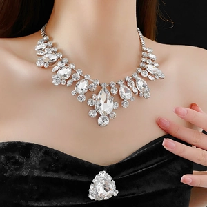 Detailed view of luxury silver water-drop crystal necklace on a black velvet dress