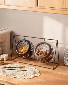 Detail of 2-tier black wire fruit basket showing the double hanging metal wire storage tiers