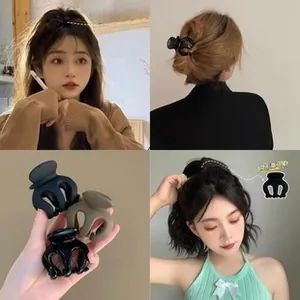 Detailed view of matte black and coffee high ponytail hair clips with secure multi-teeth grip