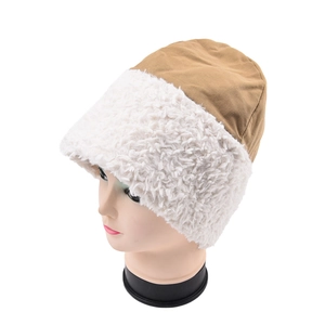 Close-up of contrast patchwork bucket hat featuring brown top and white faux shearling brim