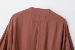 Detailed close-up of the back neckline and reinforced stitching on the suede jacket