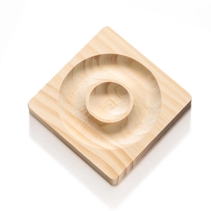 Detail view of square pine wood jewelry tray with concentric circular grooves and natural grain