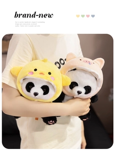 Detail of plush panda dolls in duck and pig outfits showing soft texture and size