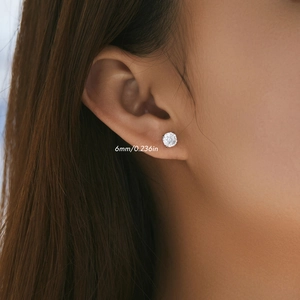 Close-up of 6mm rose-cut sparkling zircon stud earrings on female model ear