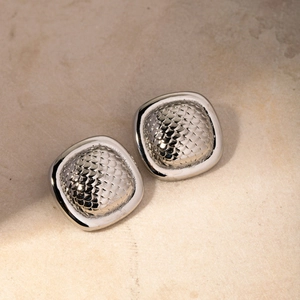 Macro shot of silver square stud earrings featuring intricate fish scale texture patterns