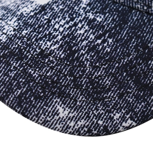 Close-up of baseball cap brim with blue snowflake camo pattern and reinforced stitching