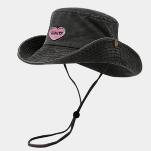 Close-up of pink heart embroidery and windproof rope on the dark grey sun hat