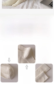 Detail of white cotton crew socks showing seamless toe and elastic ribbed cuff