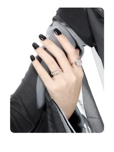 Detail view of S925 sterling silver rings with natural crystal on a hand with black nails