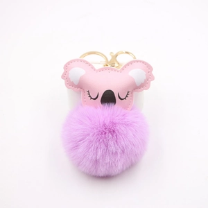 Detail of pink leather koala keychain with purple faux fur pompom and gold metal clip