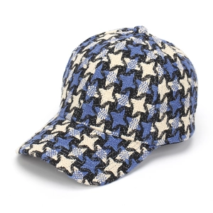 Close-up of winter tweed baseball cap with blue and black checkered weave pattern