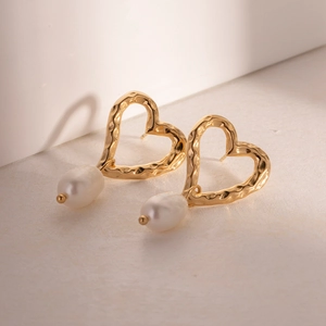 Golden heart-shaped hammered metal earrings with elegant baroque pearl pendants