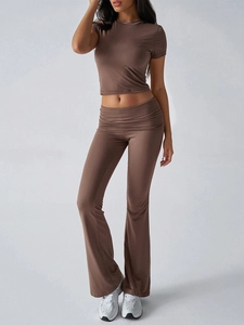 Detail of soft brown short-sleeve top and flared trousers casual set on model