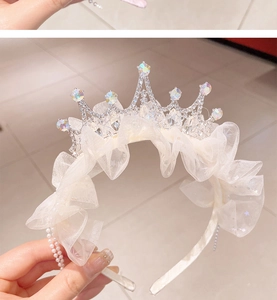 Detailed view of kids' silver crown headband with AB rhinestones and ruffled white tulle