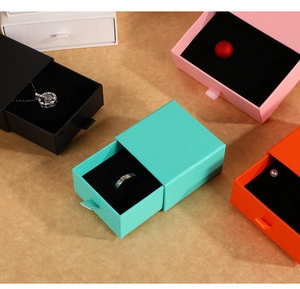 Close-up of colorful drawer-style jewelry gift boxes with protective foam inserts