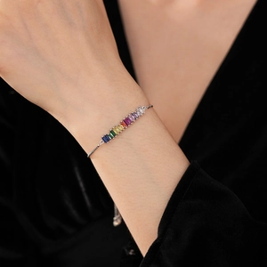 Close-up of adjustable silver bracelet with colorful rectangular-cut zircon stones